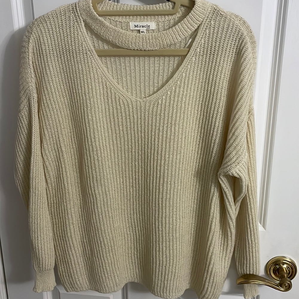 Cream size M/L long sleeve knit sweater with cutout